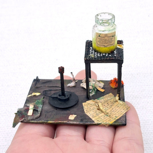 dolls house Bunsen burner and chemical lab equipment on a wooden board 