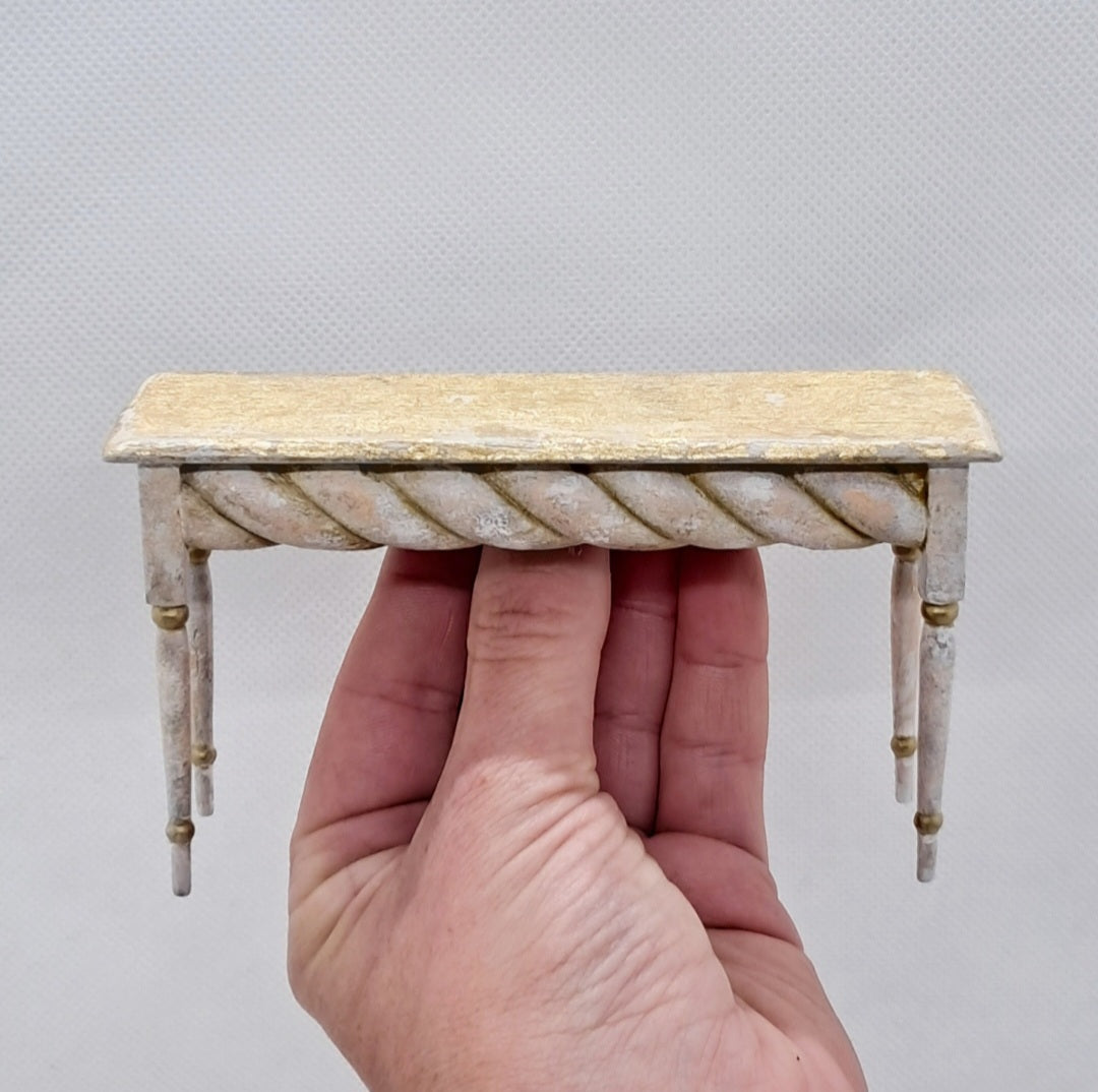 A 12th scale dolls house miniature gold leaf topped side table.