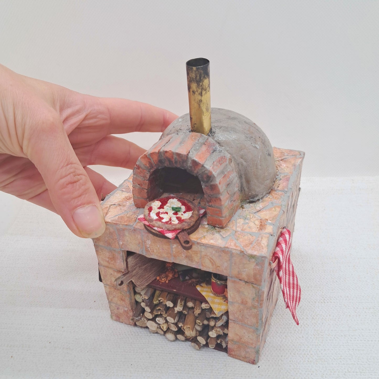 a handmade 1/12th scale miniature clay and brick pizza oven or dolls houses and miniature application. 